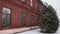 Old red brick building 18th 19th century in winter snowfall in daytime. Eldest hotel or hostel times of Russian empire