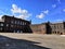 Old red brick building blue sky and clouds Old red brick building with Windows reflecting the light. architecture.Old architecture