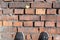 Old red brick fortress wall with gray cement mortar textute