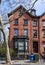 An old red brick house with a large dormer window in Brooklyn Heights, NYC