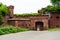 An old red brick military fort. Old tower of red brick. Old military fortification.