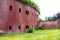 An old red brick military fort. Old tower of red brick. Old military fortification.