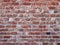 Old red brick wall, badly made.