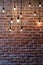 Old red brick wall with bulb lights lamp