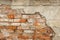 Old Red Brick wall with damaged grey plaster background