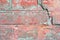 Old red brick wall with fissure, grunge texture background