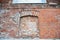 Old red brick wall inside of a vault or arch. Without Windows and doors