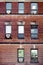 Old red brick wall with rectangle windows and air conditioners mounted in Montreal, Canada