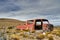 old red car wreck standing in the middle of nowhere in Patagonia.