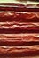 Old red crumpled iron painted horizontal corrugated fence background