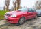 Old red Daewoo Lanos hatchback private car parked