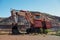 Old red excavator in Tom Price iron ore mine in Pilbara region at tourist tour