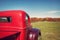 Old red farm truck against autumn landscape