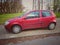 Old red Fiat Punto two doors parked