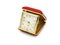 A old red folding travel alarm clock on white background