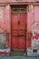 Old red front door with peeling paint