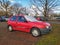 Old red Japanese compact small car Toyota Starlet parked