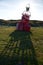 Old red metal buoy, buried half at the shore of Texel.