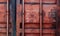 Old red shipping container door with text