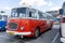 The old red Skoda bus rides through the streets of the Polish capital. Tourist bus vintage model. The street of the old