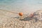 Old red styrofoam buoys on the rope lying on the beach of the sea