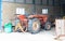 Old red tractor inside garage