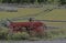 An old red wagon in the landscape in The Grand Tetons.