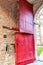 Old red wooden door divided into two parts at one of the entrances to Alden Biesen castle