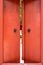 Old red wooden doors with metal ring handle