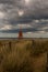 The old, red, wooden Herd Groyne Lighthouse in South Shields, stands out against the cloudy sky