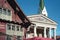 Old red wooden house and parish church