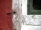 Old red wooden timber door with iron door hinge Whitewashed