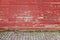 Old red wooden wall and cobblestone floor