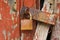 Old red wooden wall peeling texture and corroded padlock