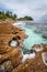 Old reef coastline and ocean waves on tropical Police Bay beach on Mahe Island, Seychelles