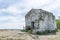 Old remote small stone chapel in Bulgaria. Historical ancient church in ruins with bench and cross. Cultural catholicism and holy