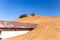 Old residential building buried in sand dune on a desert in Al Madam ghost village in Sharjah, United Arab Emirates