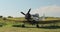 Old restored airplane standing on the ground with propeller wings and wheels