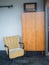 Old retro armchair, cupboard and an old vintage radio