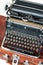 Old retro black metallic typewriter with antique round keys.