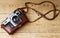 Old retro camera on vintage rustic wooden planks boards. Education photography courses back to school concept abstract background