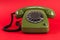 Old retro green phone on red background