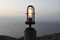 Old retro maritime light bulb next to the sea at sunrise or sunset