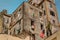 Old ,retro vintage building with various clothing in open windows on Cuban Havana street against blue sky