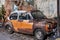 Old retro vintage car orange is abandoned at Talad Noi Market street.