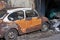 Old retro vintage car orange is abandoned at Talad Noi Market street.