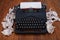 Old retro vintage typewriter with paper on wooden board