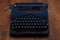 Old retro vintage typewriter on wooden board