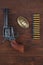 Old revolver with cartridges and U.S. Army soldier& x27;s belt with a buckle