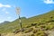 An old rickety signpost direction white sign arrow near the tracking path at the peak top of the mountain showing the right